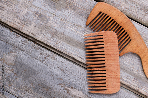Wooden hair combs and copy space. Handbag combs on wooden background.
