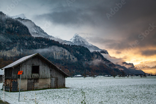 sunset and snow covered peaks in the background Switzerland