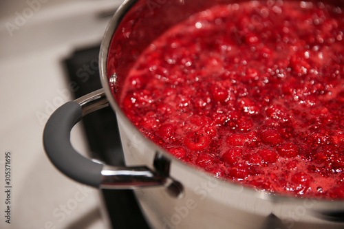 Cooked raspberry jam in a saucepan