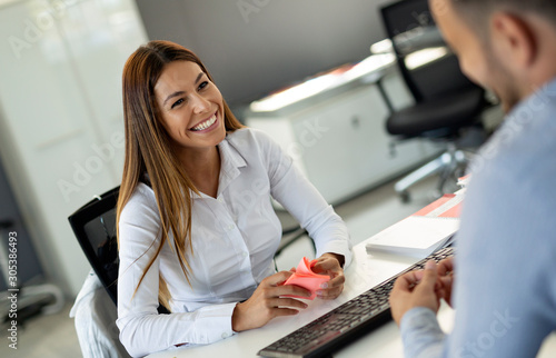 Beautiful woman manager communicates with the client in the work