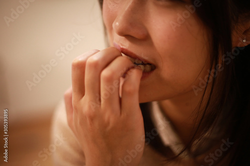 爪を噛む女性