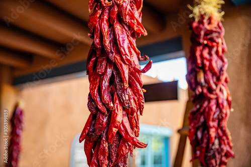 Red chili peppers dried hanging on a traditional building entrance, Santa Fe New Mexico