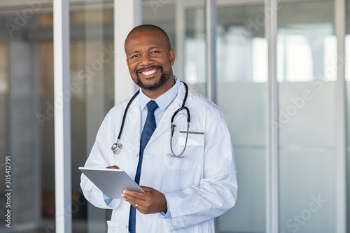 Portrait of happy african doctor at private clinic