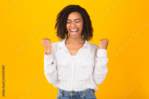 Overjoyed young black girl screaming with joy