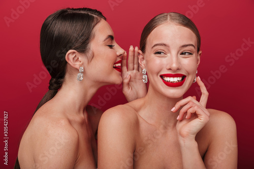 Cheery positive two women with bright red lipstick