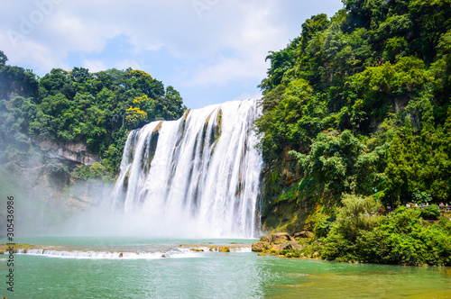 China Guizhou Huangguoshu Waterfall in Summer. One of the largest waterfalls in China and East Asia, classified as a AAAAA scenic area by the China National Tourism Administration.