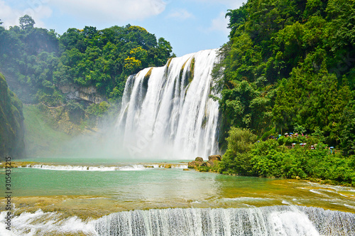 China Guizhou Huangguoshu Waterfall in Summer. One of the largest waterfalls in China and East Asia, classified as a AAAAA scenic area by the China National Tourism Administration.