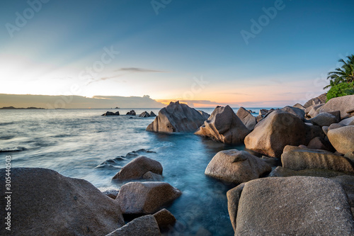amazing travel landscape photo with Sunset of the iconic rocks of seychelles , Seascape on sea with long exposure and water wave