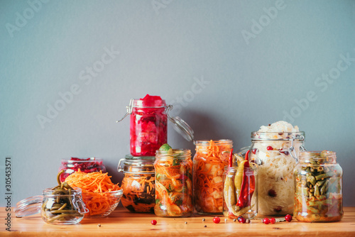 Probiotics food background. Korean carrot, kimchi, beetroot, sauerkraut, pickled cucumbers in glass jars. Winter fermented and canning food concept. Banner with copy space