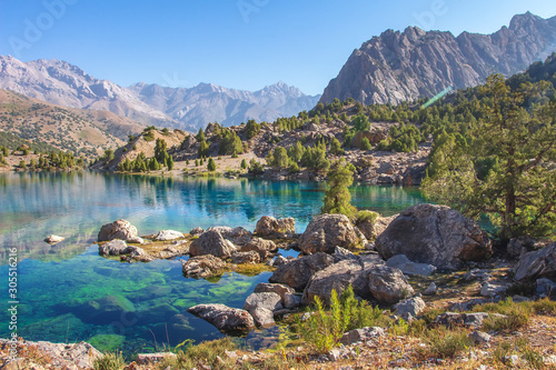 Beautiful mountain nature landscape on sunny summer day. Alaudin lake in Fann mountains, Tajikistan. Scenic with on blue water in lakes in Pamir-Alay valley