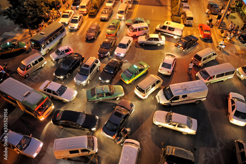 Messy traffic at crossroad at night, aerial view