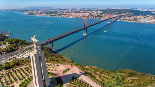 Aerial. Panorama from sky, a 25 de Abril Bridge and a statue of Jesus Christ. Lisbon.