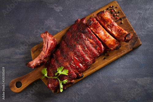 Pork loin ribs served on chopping board. View from above, top