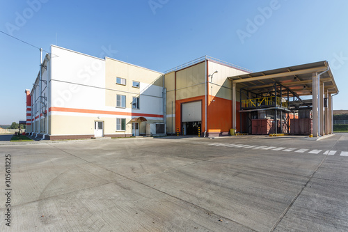 manufacture building of modern waste recycling processing plant in orange style. Separate garbage collection. Recycling and storage of waste for further disposal.