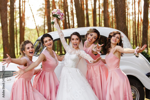 Wedding ideas. Bride and bridesmaids having fun on wedding day