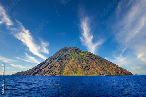 Volcanic island Stromboli in Lipari viewed from the ocean with nice clouds, Sicily