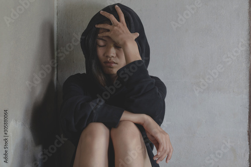  Depressed and hopeless teenage girl sitting alone after using drugs, Drugs addiction and withdrawal symptoms , No to drugs concept. International Day against Drug Abuse.