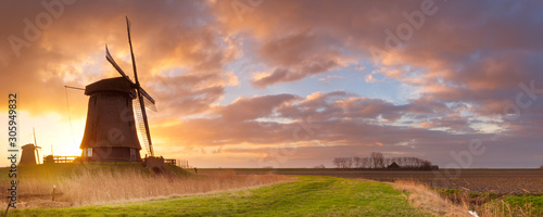 Traditional Dutch windmills at sunrise in The Netherlands