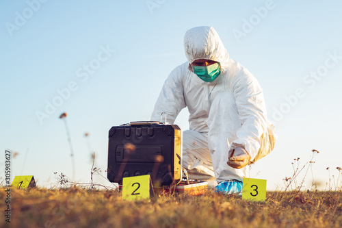 Criminologist investigates a crime scene.