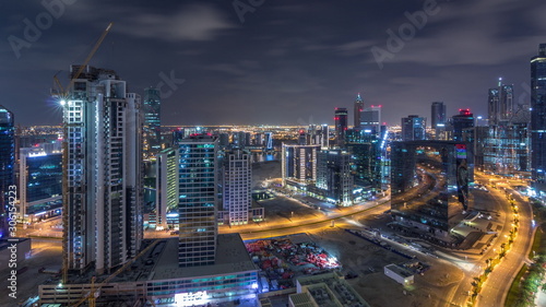 Aerial view of illuminated buildings and high traffic in modern Dubai city, United Arab Emirates Timelapse Aerial