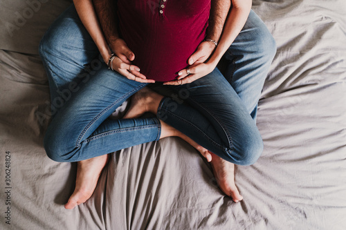 young couple at home hugging. Happy Pregnant woman smiling. top view