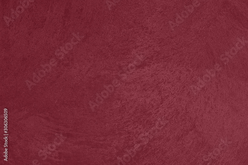 Dark red low contrast concrete textured wall background to your concept or product. Winter color trend.