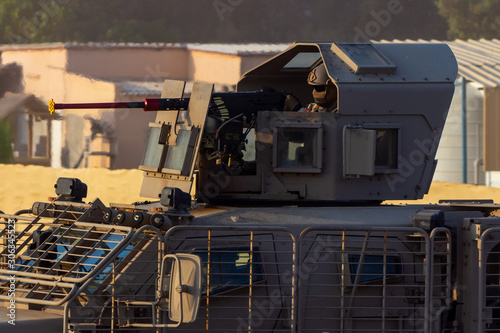 Military tank army vehicle close up of guns and military personel aiming and shooting. Military and war concept of power, force, strength.