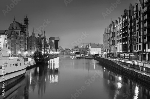 Gdansk with beautiful old town over Motlawa river at night in black and white, Poland.