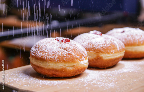 Hanukkah food doughnuts with jelly and sugar powder with bookeh background. Jewish holiday Hanukkah concept and background. Copy space for text. Shallow DOF