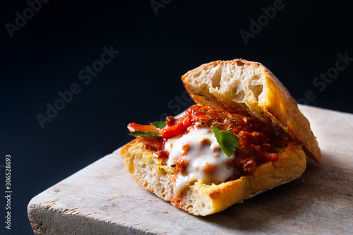 Homemade food concept Organic bolognese grill artisan bread sandwich on black background with copy space