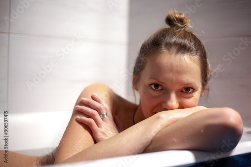 Luxury woman relaxes in hotel Spa bath or home bathroom for complete relaxation. European lady takes a bath with warm water, winter Wellness center.the concept of rest and health