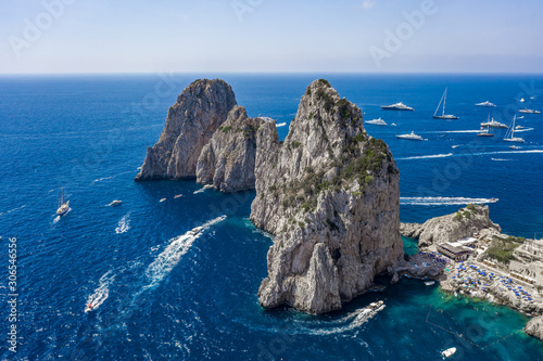 Aerial drone shot view of faraglioni limestone crags in summer time in Tyrrhenian sea off Capri Island