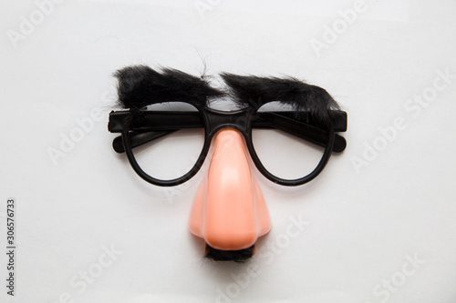 Closeup of a fake nose and glasses, with furry eyebrows