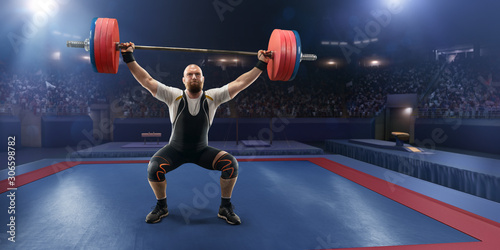 Male athlete squats with a barbell on a professional stadium. Stadium and crowd are made in 3d.