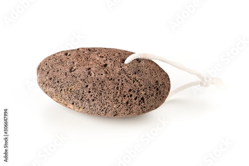 Black lava pumice stone spa or bath utensil used for peeling or callused skin removal over white