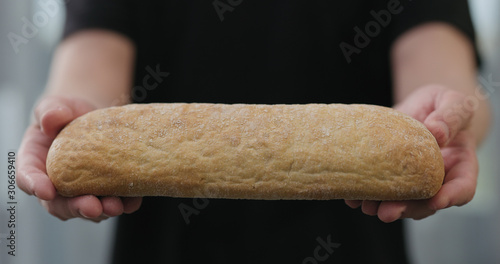 man hands show hot ciabatta bread indoors