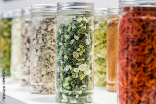 freeze dried vegetables sliced in glass jars in a shop window