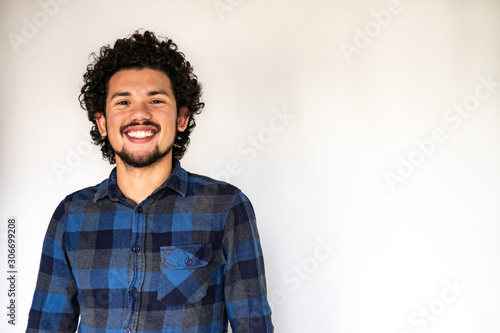 Latin American man smiling, neutral background 