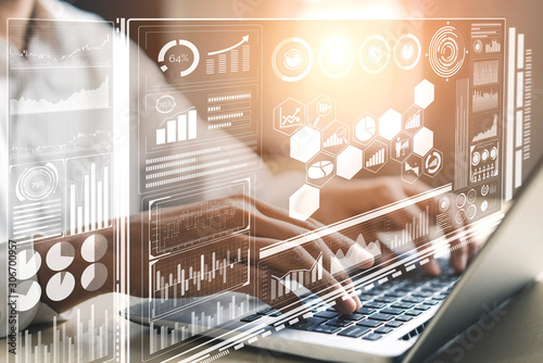 Big Data Technology for Business Finance Analytic Concept. Modern graphic interface shows massive information of business sale report, profit chart and stock market trends analysis on screen monitor.