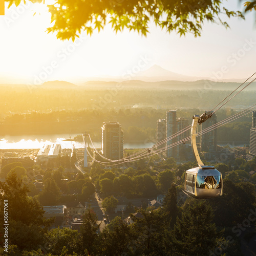 Cable car in Portland, Oregon, USA with wonderful view on sunrise with mt. Hood and aerial tram going to OHSU