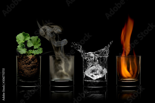 Four elements concept in glasses. earth, air, water, fire.