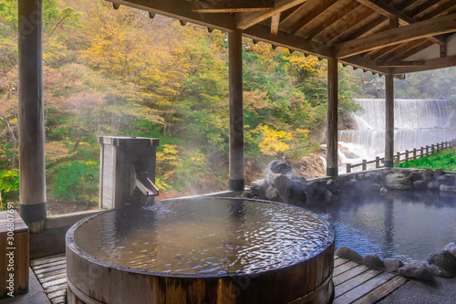 Japanese Hot Springs Onsen Natural Bath Surrounded by red-yellow leaves. In fall leaves fall in Fukushima, Japan.