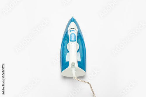 Iron for ironing things on a white isolated background. Laundry concept, tailoring studio, housework. Flat lay, top view