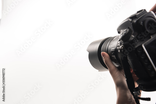 cropped view of photographer working with digital camera isolated on white