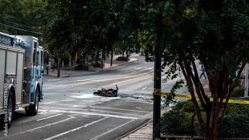 Wrecked motorcyle in front of firetruck and laying on the road after exploding in accident