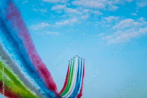 Jet planes leaving colorful trails on the sky during an airshow