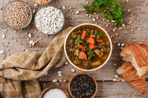 Healthy vegetable soup on a barn board background