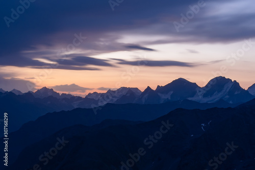 Dawn in the mountains. Old high, sharp mountain peaks on the background of the dawn. The Caucasus.