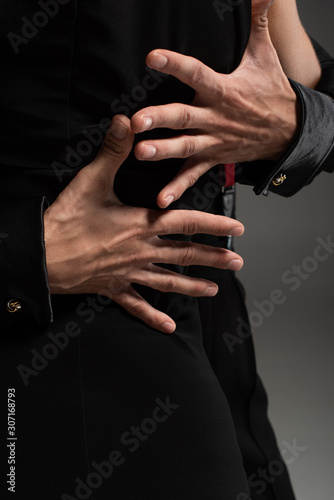 cropped view of tango dancer hugging partner isolated on grey