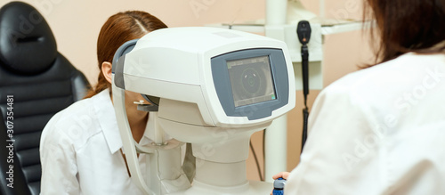 ophthalmologist doctor in exam optician laboratory with female patient. Eye care medical diagnostic. Eyelid treatment